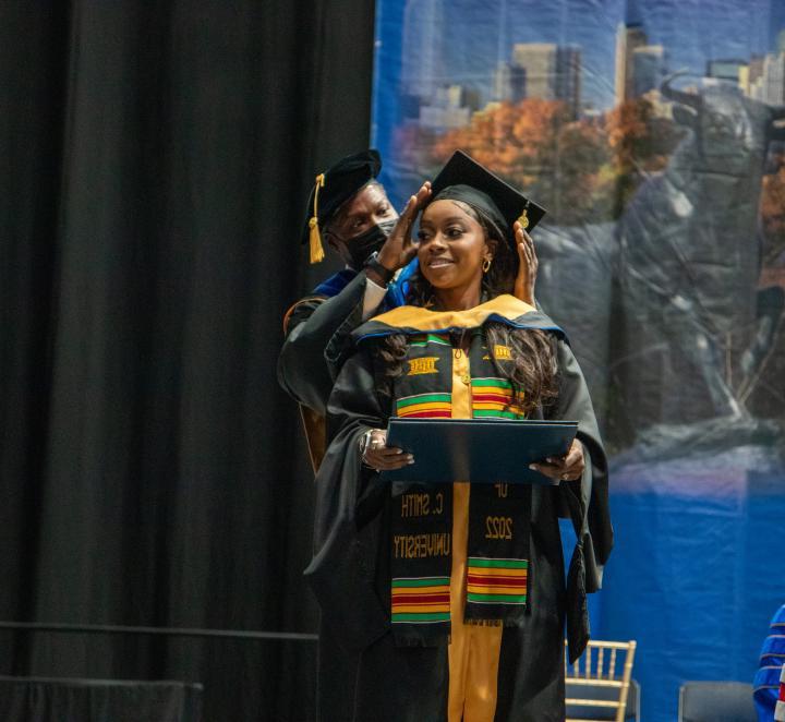MSW student at commencement 2022 receiving hood